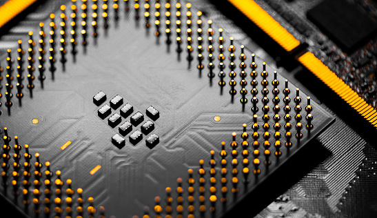 Macro Close up of RAM Memory and pins on Main CPU PC processor circuit board.