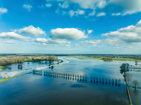 High water level in the river Vecht at the Vilsteren weir in the Dutch Vechtdal region in Overijssel, The Netherlands. The river is overflowing on the floodplains after heavy rainfal upstream in The Netherlands and Germany during storm Eunice and Franklin in February 2022.
