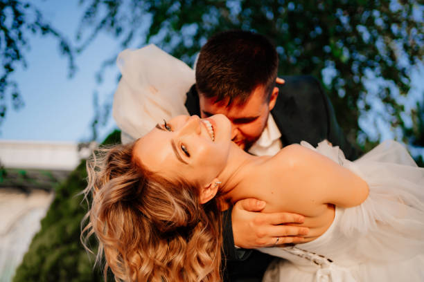istock close up. dancing happy bride and groom in nature. 1458757706