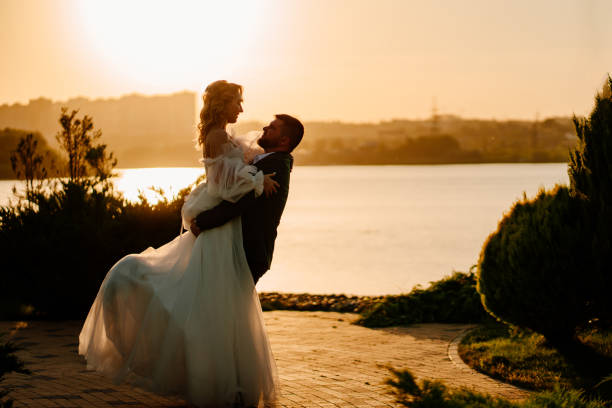 istock dancing happy bride and groom in nature. at sunset 1458758510