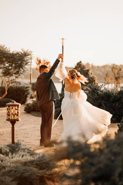 istock dancing happy bride and groom in nature. at sunset 1458758678