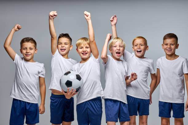 positive optimistic soccer players boys celebrating the win