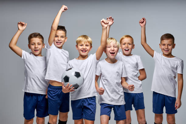 istock boys soccer team celebrating a victory after match 1458761666