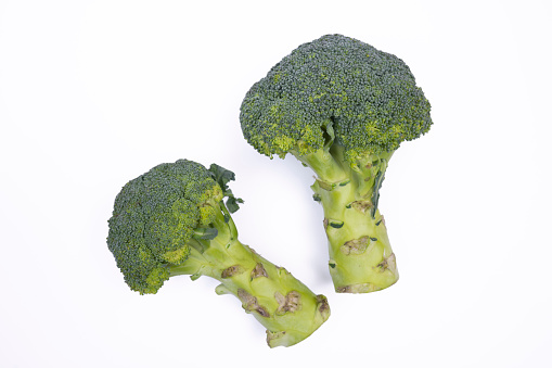 fresh broccoli on white background photographed from above