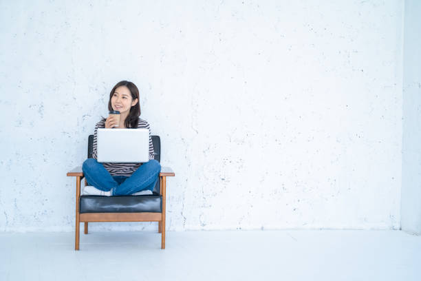 istock A woman doing remote work in a bright white living room. 1458766848
