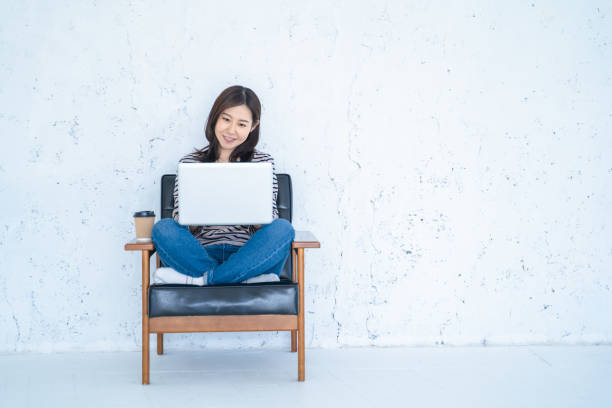istock A woman doing remote work in a bright white living room. 1458766849