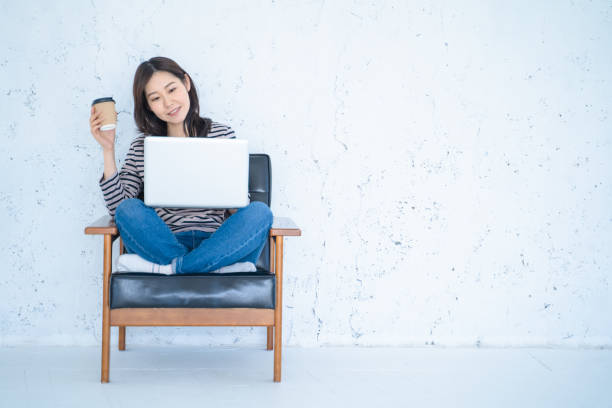 istock A woman doing remote work in a bright white living room. 1458766852