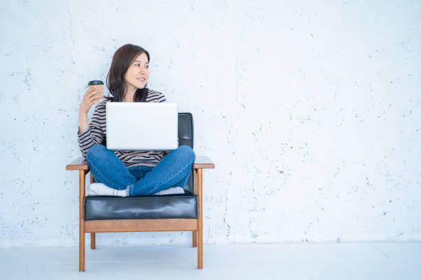 istock A woman doing remote work in a bright white living room. 1458766881