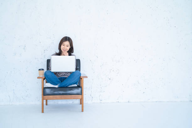 istock A woman doing remote work in a bright white living room. 1458766882