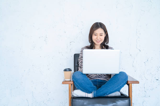 istock A woman doing remote work in a bright white living room. 1458766939