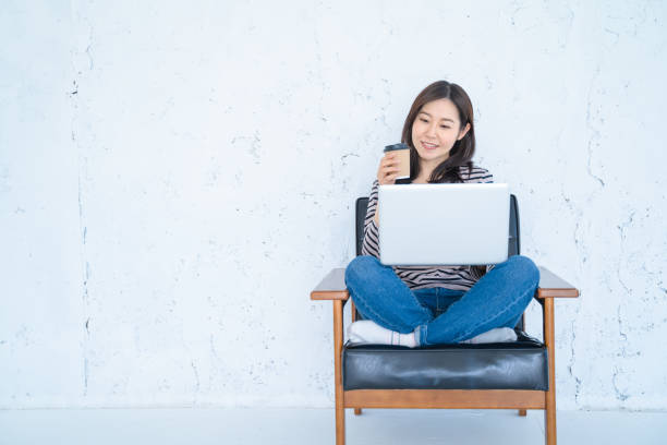 istock A woman doing remote work in a bright white living room. 1458766961