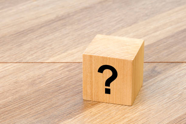 istock natural wooden cube or dice with question mark 1458772819