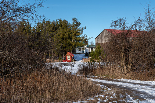 This photograph of the red shed on the side of the road was taken on December 13, 2022 during the trip to the Rinas tree farm in the early afternoon.