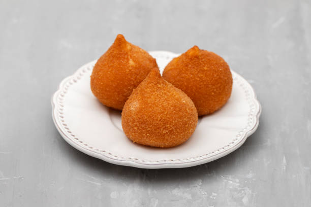 istock traditional brasilian fried drumsticks Coxinha de frango on dish 1458779642