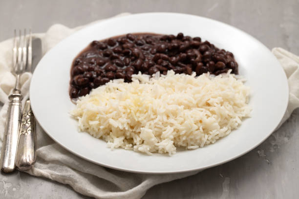 istock Black beans and boiled rice on white dish. 1458779656