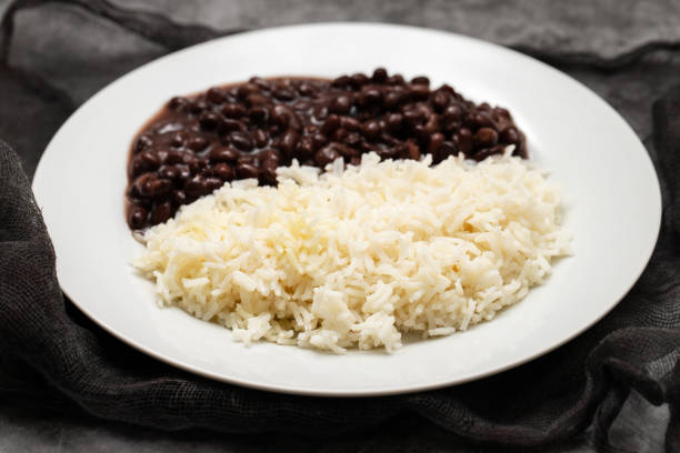 istock Black beans and boiled rice on white dish. 1458779711