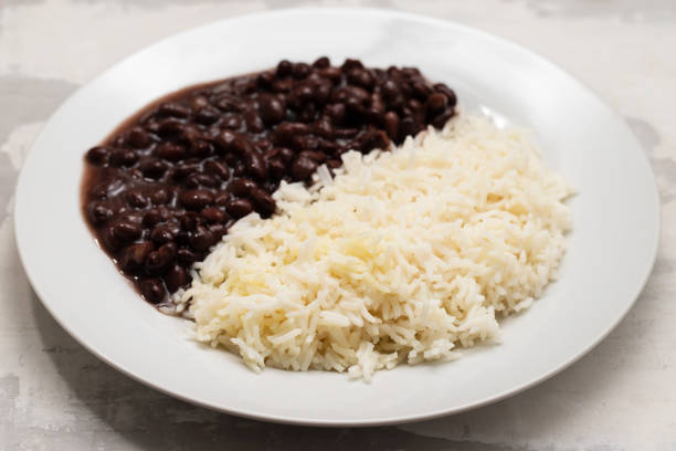 istock Black beans and boiled rice on white dish. 1458779732