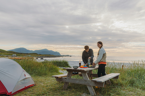 Wooden Picnic table in Iceland, on the green meadow. Travel outdoor summer background