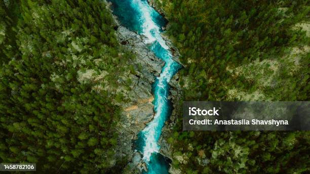 Scenic Aerial View Of The Mountain Landscape With A Forest And The Crystal Blue River In Jotunheimen National Park Stock Photo - Download Image Now