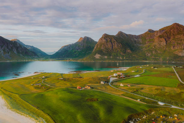Aerial view of the fisherman village by the ocean and the mountains during scenic sunset on Lofoten Islands stock photo