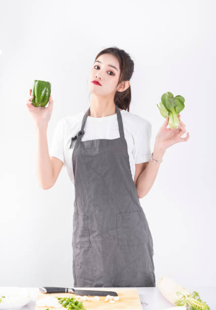 istock A woman with a vegetable in her hand 1458782799