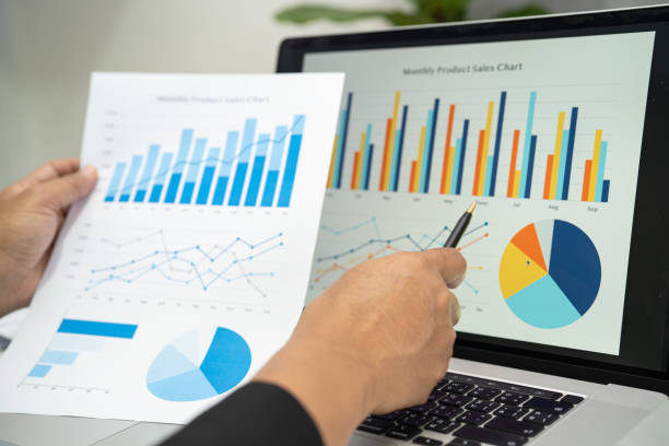 istock Asian accountant working and analyzing financial reports project accounting with chart graph and calculator in modern office, finance and business concept. 1458782983