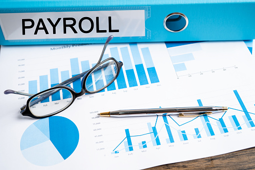 Payroll. Binder data finance report business with graph analysis in office.