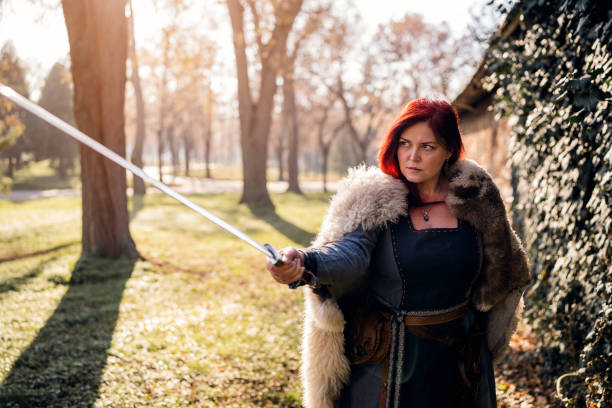 istock Medieval female warrior with sword in the forest 1458783189