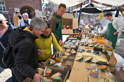 Alkmaar, Holland - April 22, 2022: various types of cheese for sale at traditional Cheese Market in Alkmaar, Holland