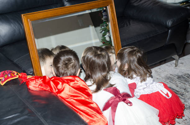Mixed race (chinese and caucasian) boy and girls dressed up in traditional chinese clothes for new chinese year and playing in front of mirror