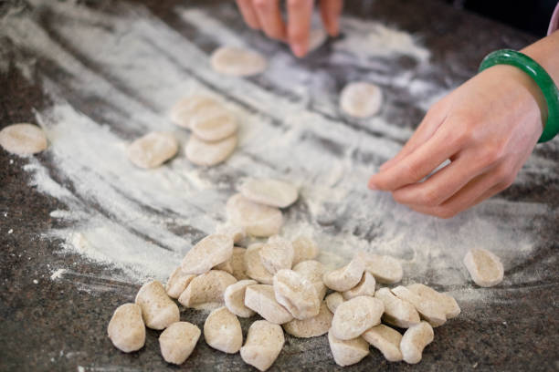 istock Cut the dough for the dumplings. 1458787732