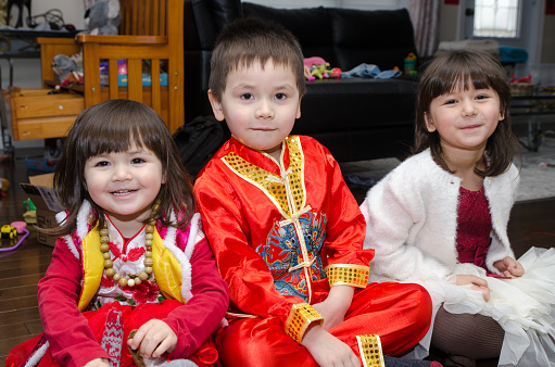 Mixed race (chinese and caucasian) boy and girl dressed up in traditional chinese clothes for new chinese year
