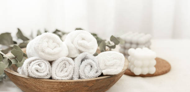 istock Spa composition with white towels in a wooden plate. 1458788794