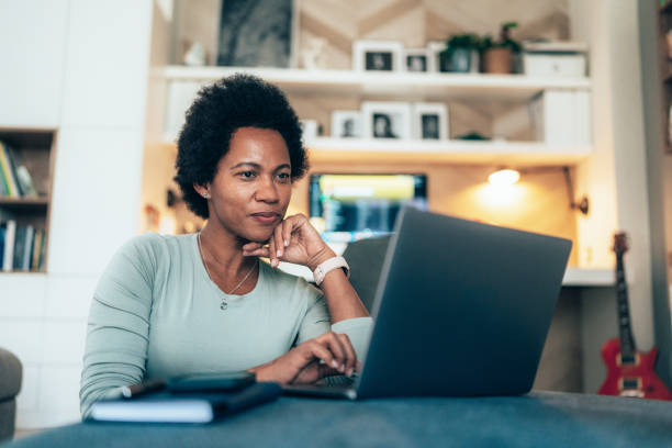 istock Woman with laptop at home 1458793852