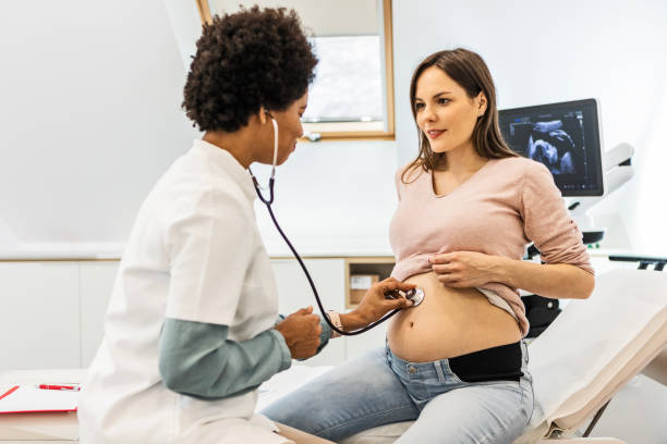 istock Checkup on a pregnant woman with a stethoscope 1458795941