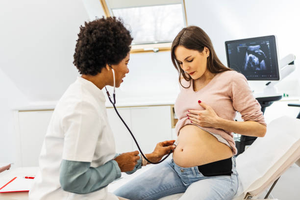 istock Doctor doing a checkup on a pregnant woman 1458795942
