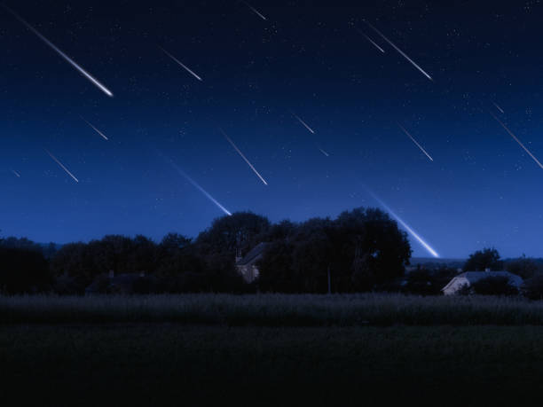 istock Shooting stars in the sky above the fields and trees. 1458797677