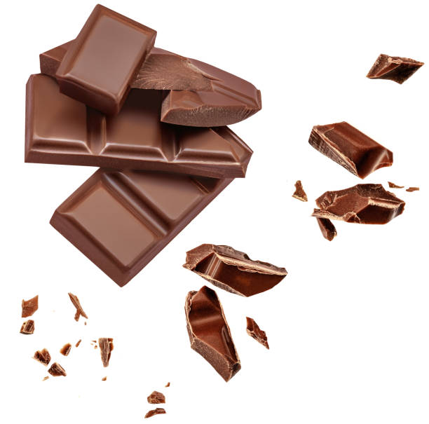 istock  Levitating milk chocolate chunks isolated on white background. Flying Chocolate pieces, shavings and cocoa crumbs Top view. Flat lay 1458798464