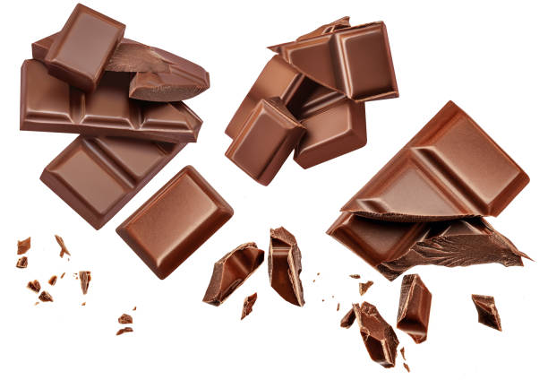 istock Dark chocolate chunks isolated on white background. Collection. Flying Chocolate pieces, shavings and cocoa crumbs Top view. Flat lay. Pattern 1458798476