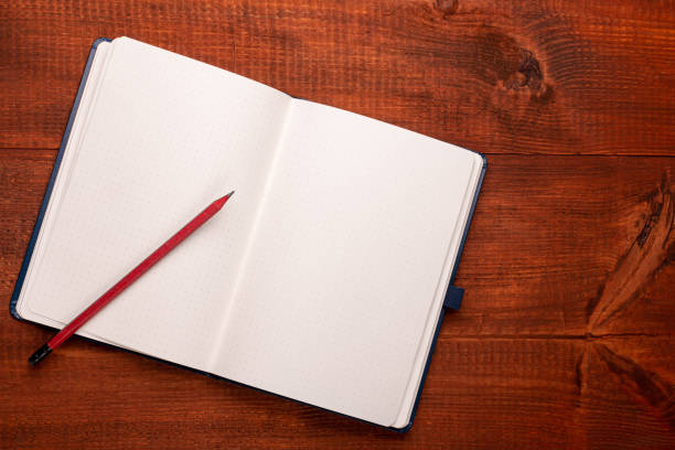 istock Open notebook with a pencil on a wooden table 1458799302