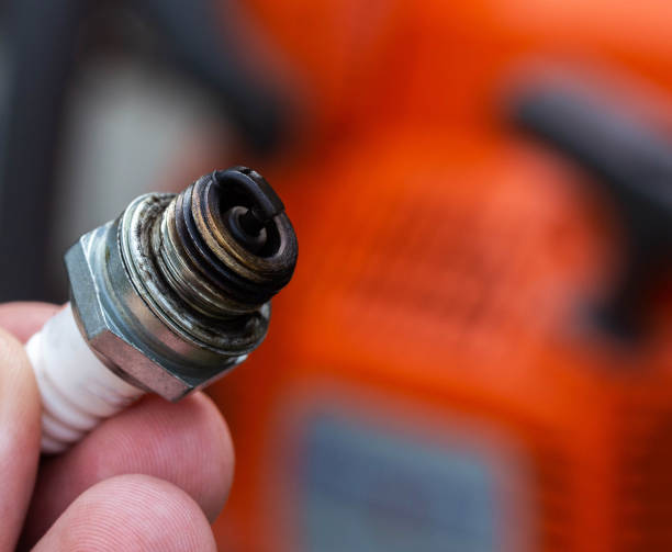 istock Wet spark plug in a chainsaw. Rich fuel mixture. Malfunction in the ignition system. industry 1458800904