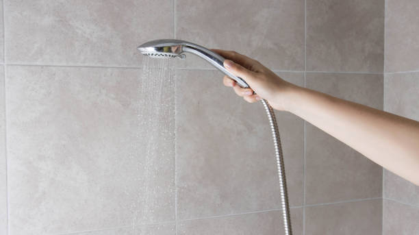 istock Hand shower head with water jet pressure switch. Hygiene and freshness. Copy space for text, spray 1458804163