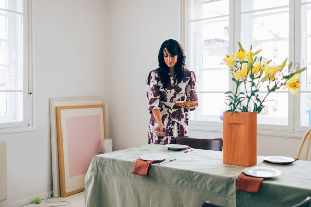 istock A Happy Beautiful Woman Preparing The Table For Lunch 1458805121
