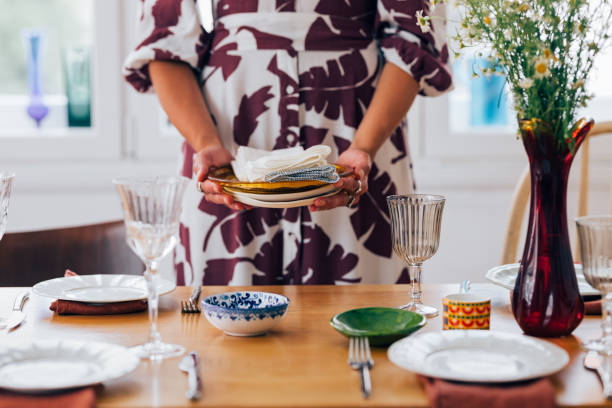 istock An Unrecognizable Beautiful Woman Preparing The Table For Lunch 1458805140