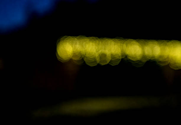 Bokeh effect defocused Christmas lights around a house doorway.