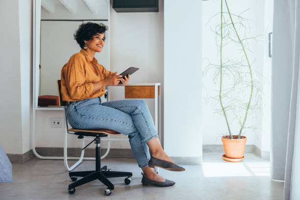 istock A Happy Beautiful Businesswoman Working From Home Using Her Tablet 1458806777