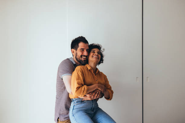 istock Love Is In The Air: A Happy Beautiful Couple Hugging While  Spending Their Leisure Time Together At Home 1458806814