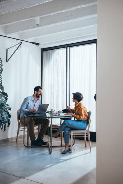 istock Two Happy Colleagues Cooperating While Sitting In The Office 1458806968