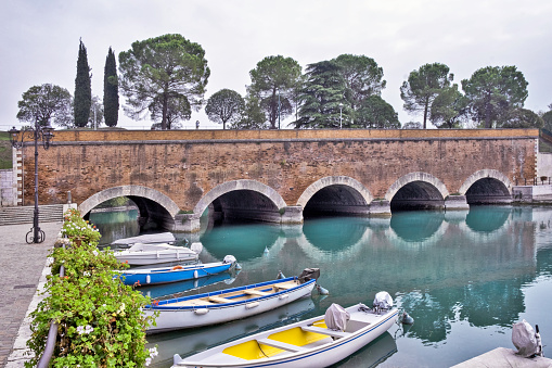 View of the canal and Volton bridge in Peschiera Del Garda, Italy.