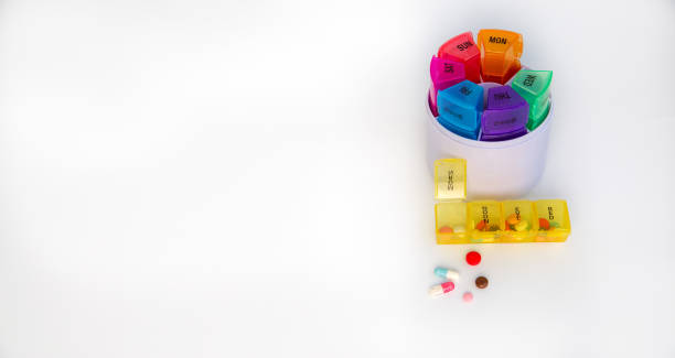 istock Pill box with various pills and capsules on a white background with copy space. Medicine, pharmaceuticals, treatment and prevention of diseases. 1458808851